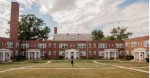 Exterior view of Oaklee Village Apartments featuring landscaped grounds and brick architecture in Baltimore, MD.
