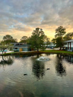 Scenic view of a pond with ducks and surrounding apartments at Palms at Sand Lake, Tampa, Florida.