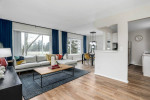 Stylish living room with oversized sliding door to patio, featuring modern decor and ample natural light.