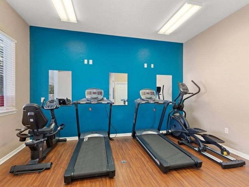 Fitness center with treadmills and elliptical machines in Miramar apartment, Kissimmee, FL