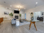Interior of a stylish clubhouse with modern furnishings and a cozy fireplace at Sycamores apartments, Reston, VA.