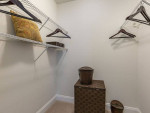 Spacious walk-in closet with shelves, hangers, and storage boxes in Reston VA apartment