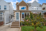 Charming semi-attached single-family home for sale in Marine Park, Brooklyn with a front yard and steps leading to the entrance.