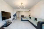 Spacious living room in a Brooklyn apartment with modern furnishings and ample natural light.