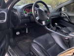 Interior view of a 2004 Supercharged GTO showcasing the dashboard and leather seats, highlighting its classic muscle car design.