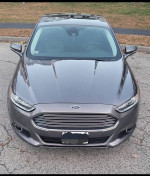 Front view of a 2013 Ford Fusion Titanium AWD in great condition with a sleek design