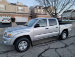 2010 Toyota Tacoma SR5 TRD Sport Quad Cab 4x4 with 73,000 miles parked on a residential street