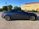 Side view of a fully loaded 2008 Infiniti G37 Sport Coupe in blue under clear skies
