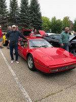 1989 Ferrari 328 GTB in red, showcasing its flawless condition at a car meet, with minimal mileage.
