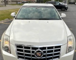 Front view of a 2013 Cadillac CTS in pearl white, showcasing its luxury features and sleek design.