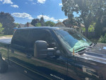 2006 Chevrolet Silverado 2500 HD with aftermarket headlights parked in a sunny neighborhood