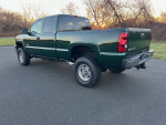 Green Chevrolet 2500 HD Duramax diesel truck parked outdoors, showcasing its clean condition and robust build.