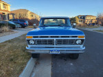 Front view of a 1977 Ford F150 4x4 Pickup truck, showcasing its classic blue color and robust design.