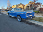 1977 Ford F150 4x4 Pickup in blue, parked on a residential street, showcasing its classic style and rugged design.