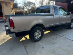 1998 Ford F150 truck in typical condition with noticeable damage to the front fender and original owner history.