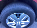 Close-up of the alloy wheel and tire of a 2016 Subaru Outback, showcasing good tread and clean appearance.