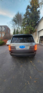 Rear view of a 2018 Land Rover Range Rover HSE 4WD parked in excellent condition, showcasing luxury design.