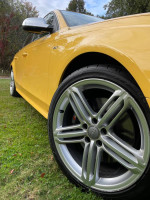 2010 Audi S4 in unique yellow color with stylish alloy wheels parked on grass