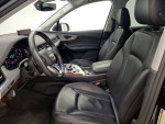 Interior view of a 2019 Audi Q7, showcasing black leather seats and modern dashboard features in an SUV.