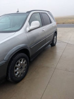 2007 Buick Rendezvous CXL FWD parked on concrete, showcasing new tires and clean body in foggy weather.