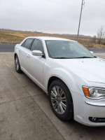 2014 Chrysler 300 in good condition with 110,000 miles, showcasing its sleek design and AWD capability.
