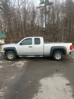 2012 Chevrolet Silverado 1500 4x4 extended cab in silver with low mileage parked outdoors