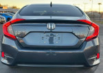 Rear view of a gray Honda Civic with a sleek design and modern taillights.