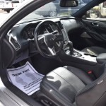 Interior view of an INFINITI Q60 coupe showcasing the leather seats and modern dashboard features.