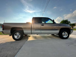 2001 Dodge Ram 1500 V8 Laramie SLT parked with a clean exterior and sun shining in the background.