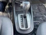 Close-up of the automatic gear shifter in a 2010 Kia Soul with black fabric seats.