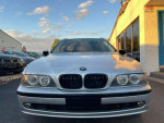 Front view of a 2002 BMW 5 Series 525i wagon in silver, showcasing its sleek design and headlights.