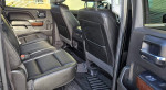 Interior view of 2018 GMC Sierra 1500 SLT 4x4 with black leather seats and spacious rear cabin.
