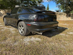 1994 Ford Mustang GT in black, showing rear and side view, with clean title and low mileage.