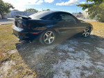 Black 1994 Ford Mustang GT coupe with a supercharged 347ci engine and clean title, parked on gravel.