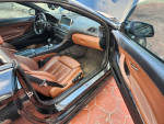 Interior view of a 2014 BMW 6 Series 640i convertible featuring black and brown leather seats.