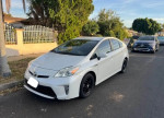 2012 Toyota Prius Four in white color parked on the street with clean title and great fuel efficiency.