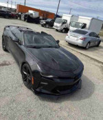 2017 Chevrolet Camaro 1LS in black, featuring aggressive styling and sporty design, parked outdoors.