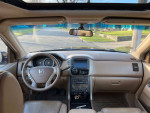 Interior view of a 2007 Honda Pilot EX with navigation and remote start, showcasing clean dashboard and features.