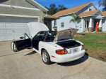 1999 Mazda MX-5 Miata touring package parked with the trunk open, showcasing its sporty design.