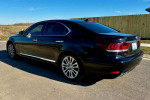 2013 Lexus LS 460 L parked in a scenic area, showcasing its sleek black design and premium wheels.