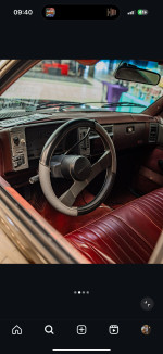 Interior view of a 1992 Chevrolet S-10 Tahoe with red leather seats and a classic steering wheel.