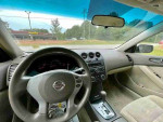 Interior view of a 2008 Nissan Altima 2.5 with leather seats and control panel, ready for sale.