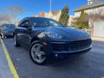 2015 Porsche Macan S AWD in black with a sleek design parked on the street.