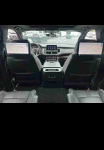 View of the interior of a 2021 Chevrolet Suburban LS with touchscreen displays and spacious seating.