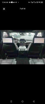 Interior view of a 2021 Chevrolet Suburban LS showing spacious seating and dual rear screens for entertainment.