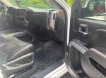 Interior view of a 2014 GMC Sierra 1500 showing black leather seats and dashboard features