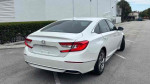 Rear view of a white 2018 Honda Accord EX-L showcasing its stylish design and spacious features.