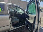 Interior view of a silver 2016 Toyota Tacoma Double Cab with spacious seating and modern dashboard.