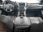 Interior view of a 2019 Chevrolet Suburban LS, showcasing leather seats and dashboard features.