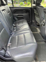 Interior view of 2007 Honda Pilot EX-L back seat with leather upholstery and space for passengers.